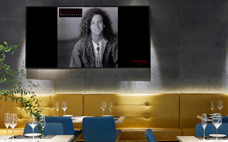 Restaurant screens showing album art